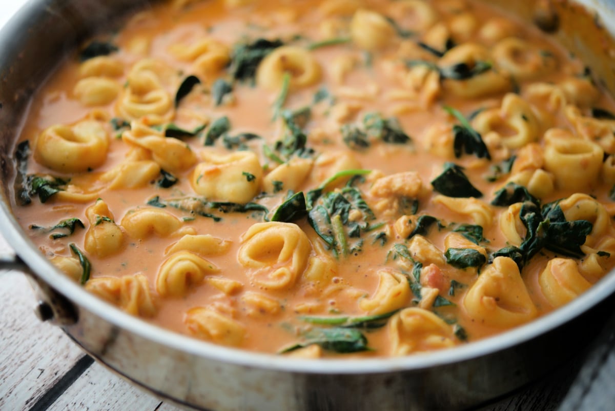 chicken tortellini and spinach in a skillet