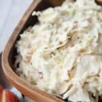 coleslaw with apples in a wooden bowl