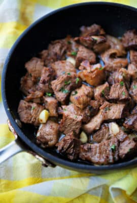 a close up of steak bites in a skillet