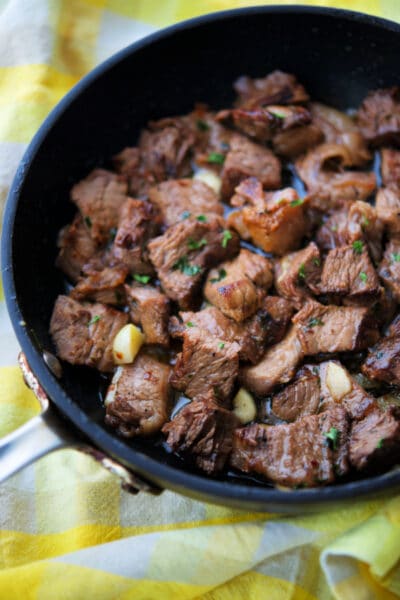 a close up of steak bites in a skillet