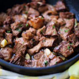 a close up of steak cut up in a pan