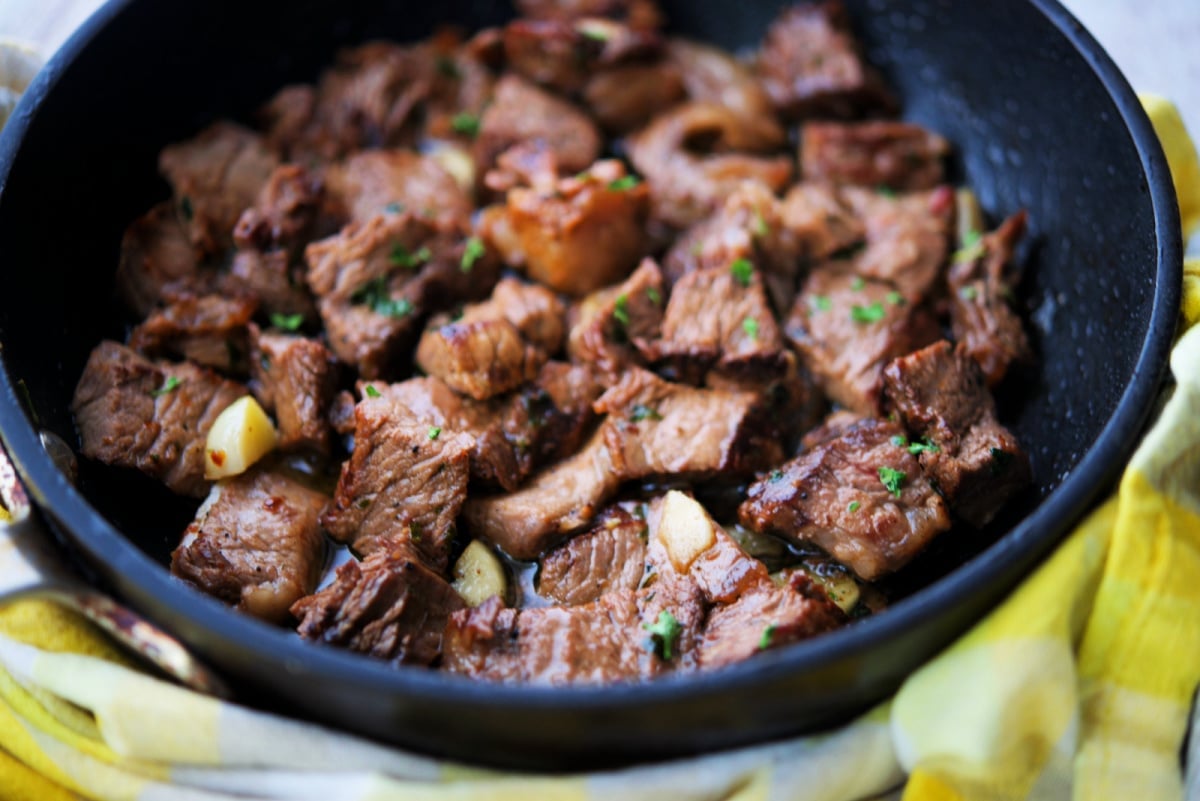 a close up of steak cut up in a pan