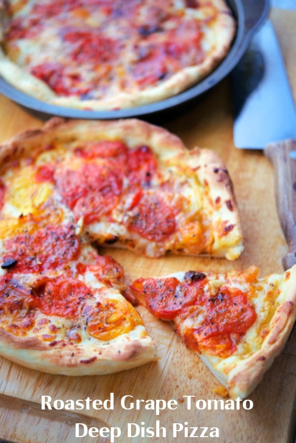 thick crust pizza with tomatoes with a slice cut out