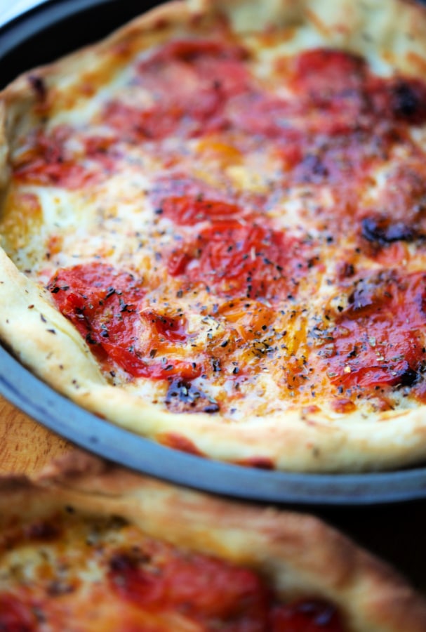 pizza in a pan with tomatoes