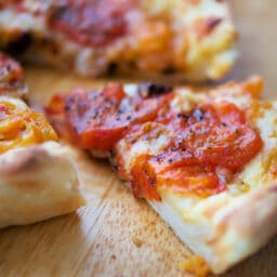 a slice of deep dish pizza on a cutting board