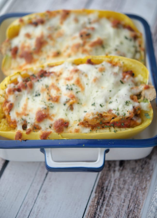 two cooked spaghetti squashes stuffed with sauce