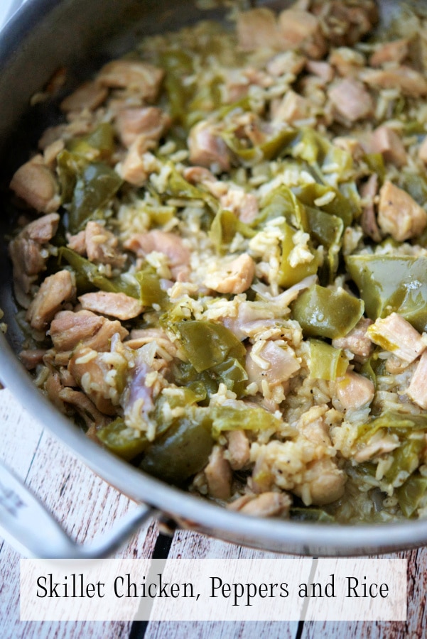 a pan with chicken, rice and peppers 