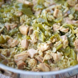 a closeup of a skillet with chicken and peppers