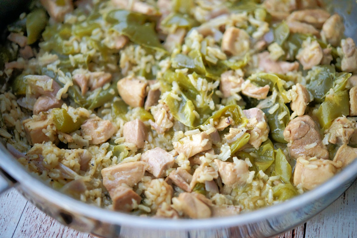 a closeup of a skillet with chicken and peppers