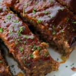 sliced bbq meatloaf in a white baking dish