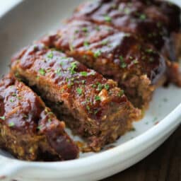 a close up of meatloaf sliced with bbq sauce