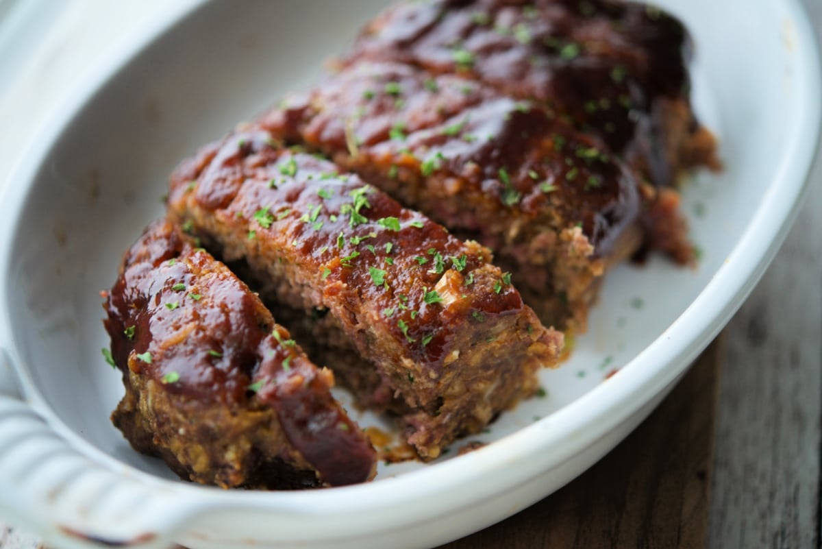 a close up of meatloaf sliced with bbq sauce