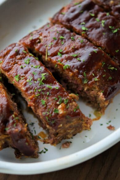sliced bbq meatloaf in a white dish