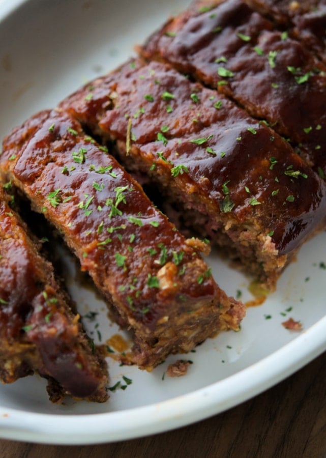 sliced bbq meatloaf in a white dish