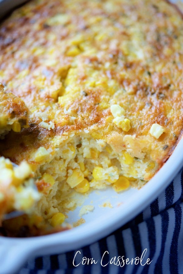 a dish of cooked corn casserole with a scoop taken out of it.
