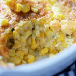 a close up of a baked corn casserole with a spoonful taken out