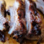 three spareribs on a cutting board