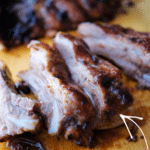 a close up of ribs cooked with balsamic peach bbq sauce