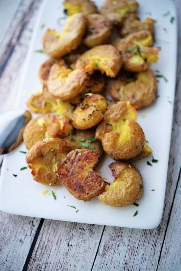 a white plate with smashed potatoes