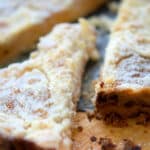 a close up of a piece of apple pie tart cut out of the whole