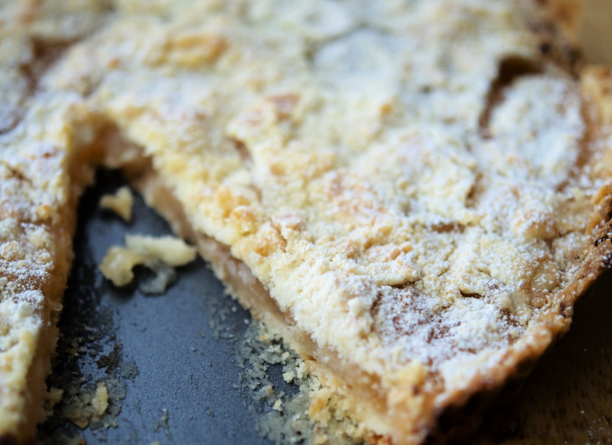 a close up of an apple tart with a piece cut out