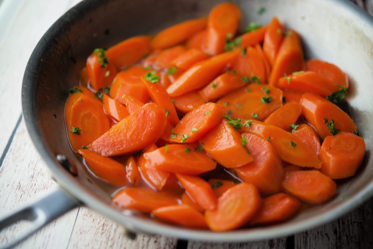 a close up of carrots in a skillet