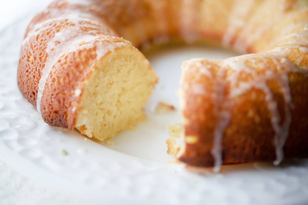key lime bundt cake with a piece cut out