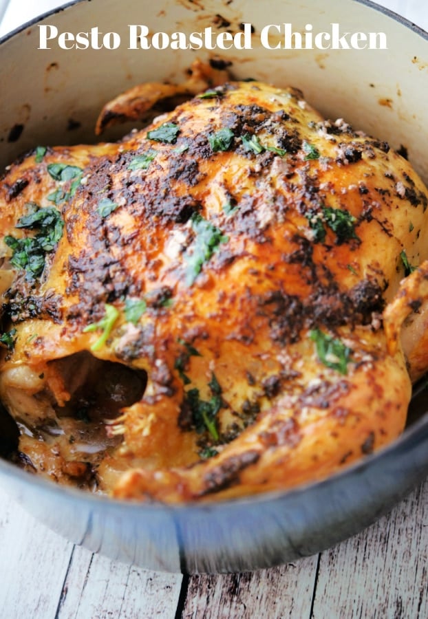 whole chicken with pesto in a dutch oven