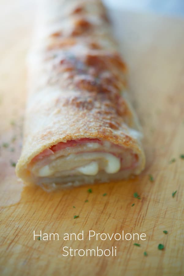 a stromboli on a wooden cutting board