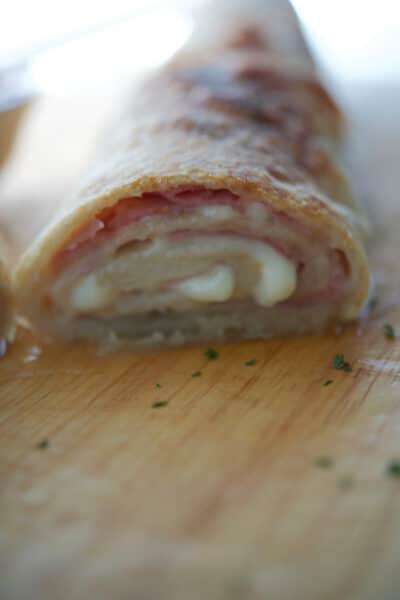 a close up of ham and cheese stromboli