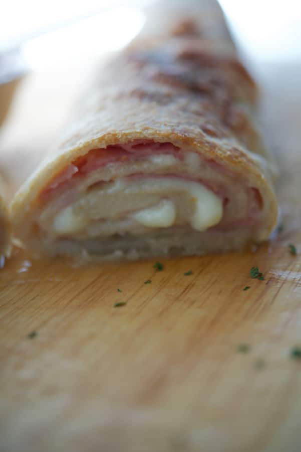 a close up of ham and cheese stromboli