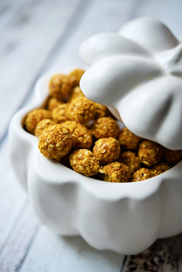 pumpkin oat puppy bites in a white pumpkin bowl