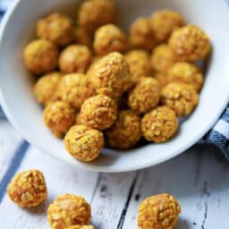 a close up of oat pumpkin dog treats in a white bowl