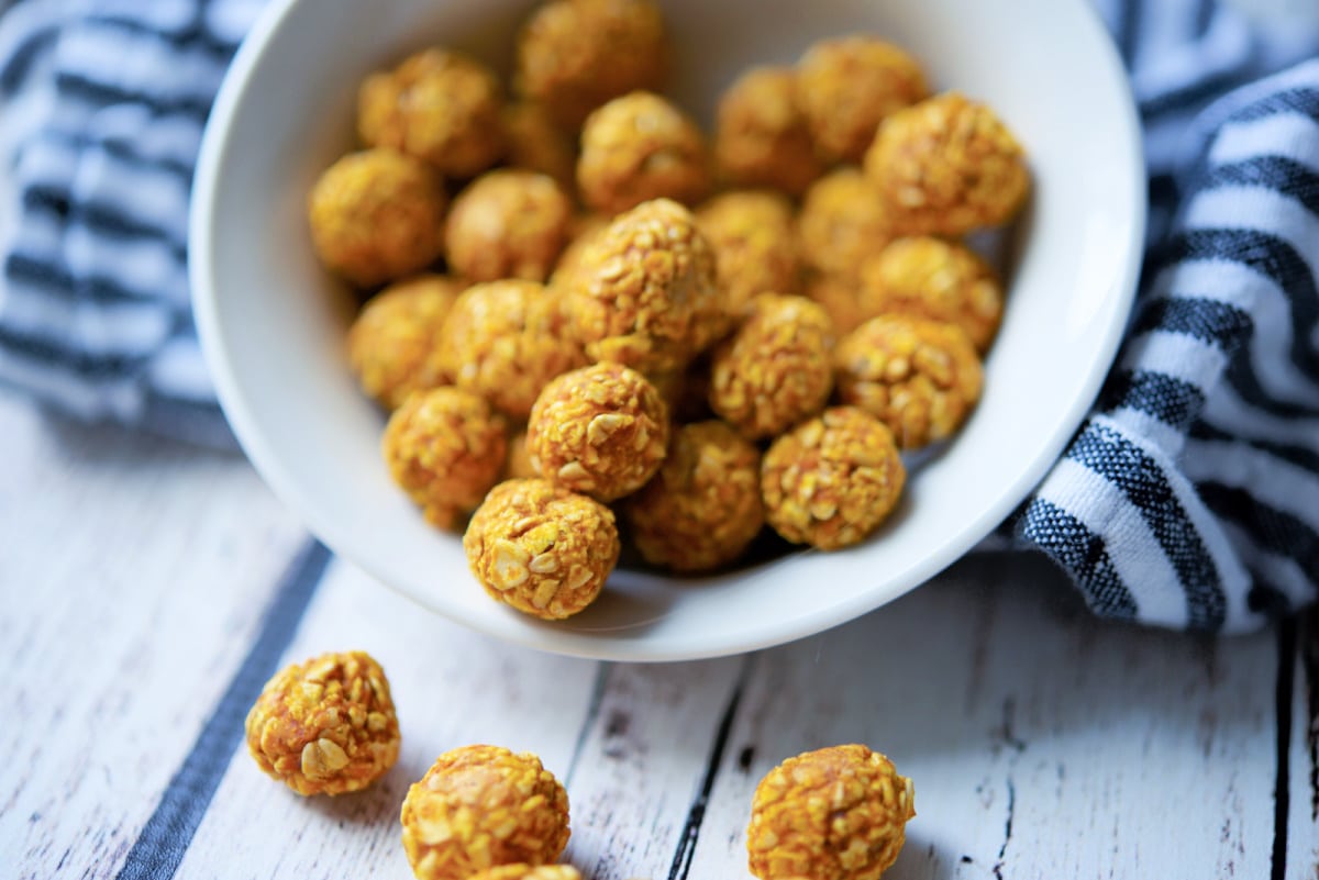 a close up of oat pumpkin dog treats in a white bowl