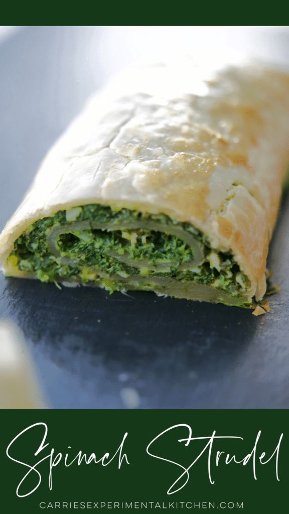 a close up of savory spinach strudel on a slate plate