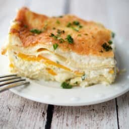 a close up of a slice of lasagna with butternut squash