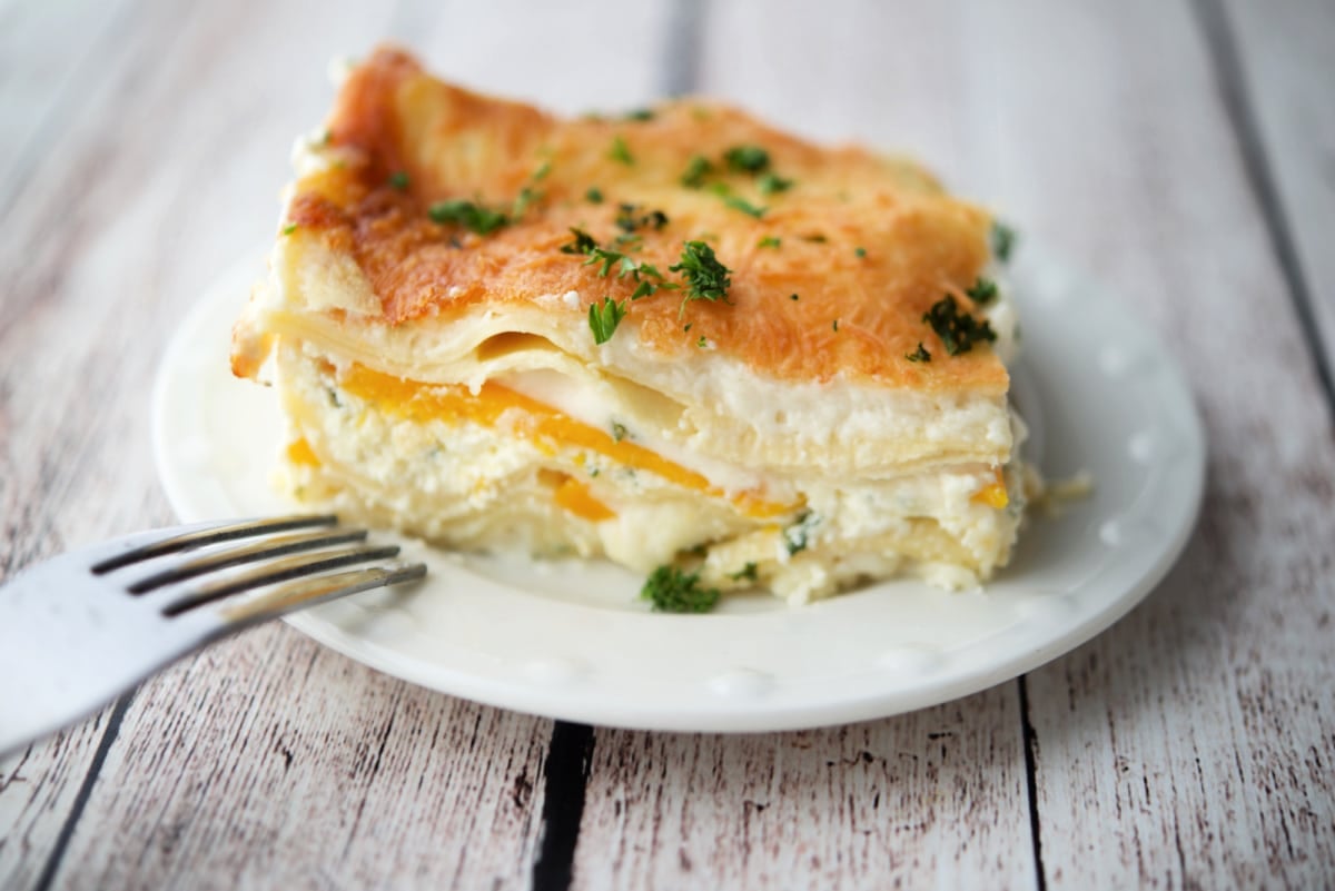 a close up of a slice of lasagna with butternut squash