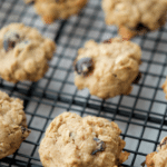 a close up of mini cranberry oatmeal cookies on a cooling rack