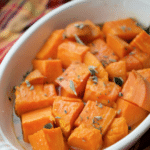 maple roasted sweet potatoes in a white casserole dish