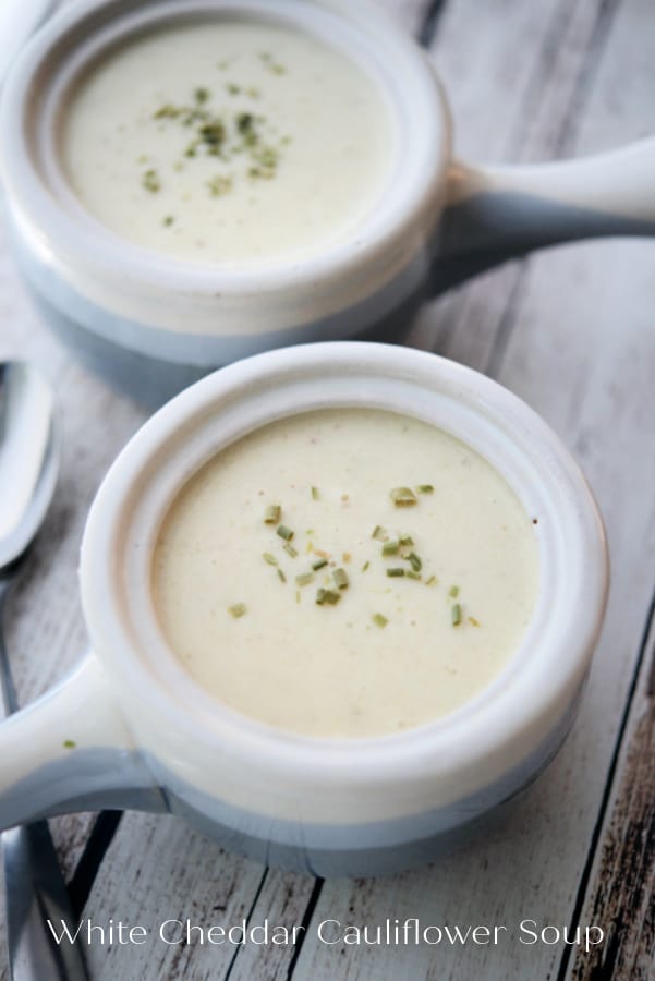 two soup crocks filled with cauliflower soup