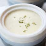 white cheddar cauliflower soup in a soup crock