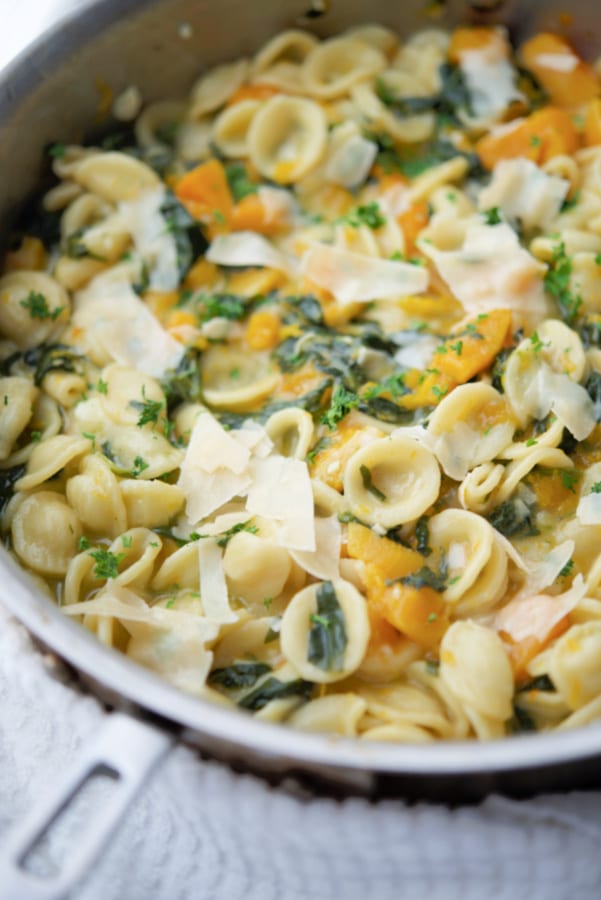 butternut squash and spinach in a skillet with pasta