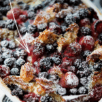 mixed berry french toast casserole in a white dish