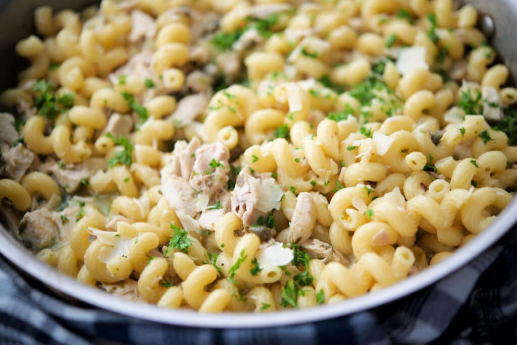 close up of turkey piccata pasta in a skillet