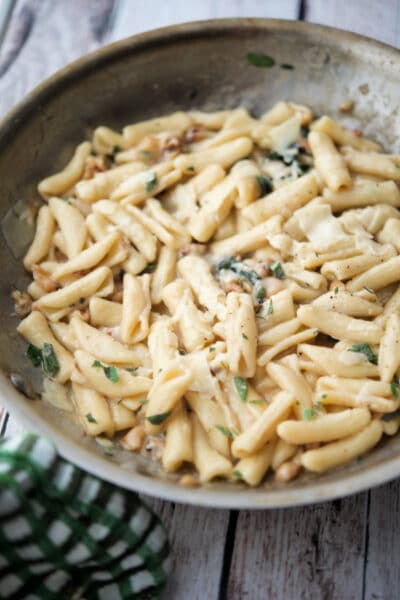 cavatelli in a skillet with sage and walnuts