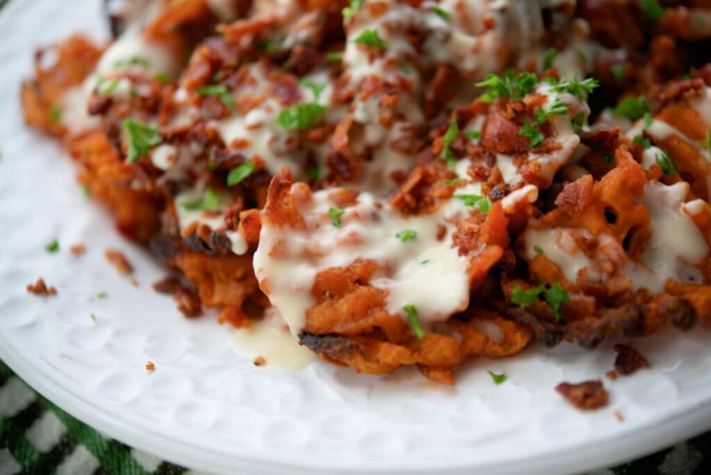 a close up of sweet potato fries on a white plate