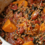 a pot of chourico, sweet potato and spinach stew