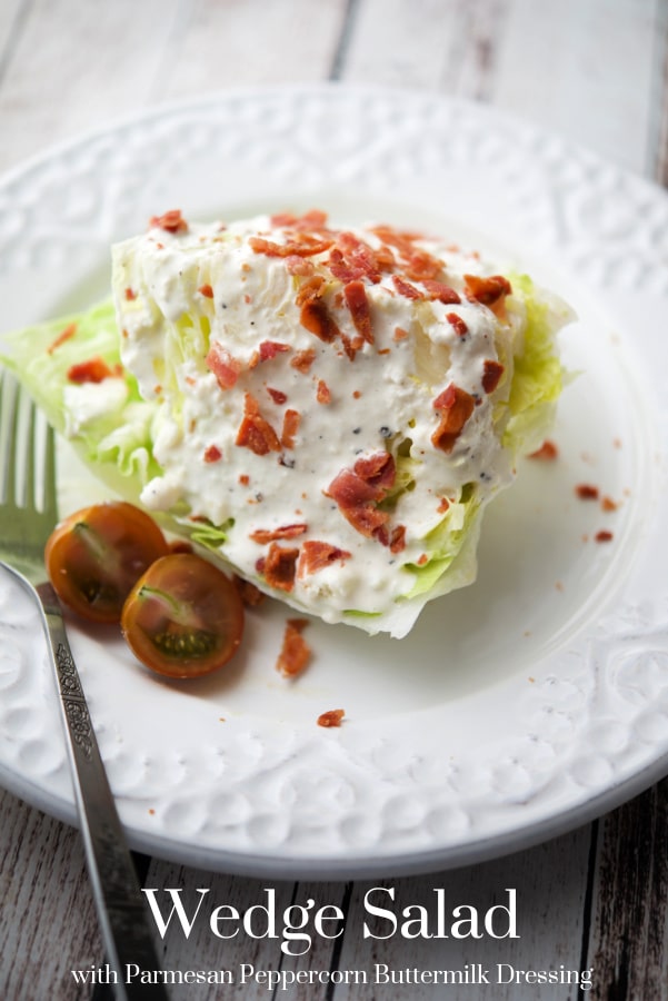 a wedge of iceberg lettuce with parmesan peppercorn dressing