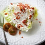 iceberg wedge salad on a white plate