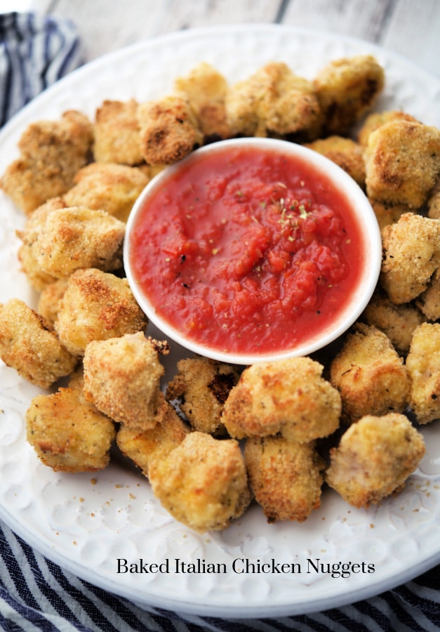 chicken nuggets on a plate with marinara sauce
